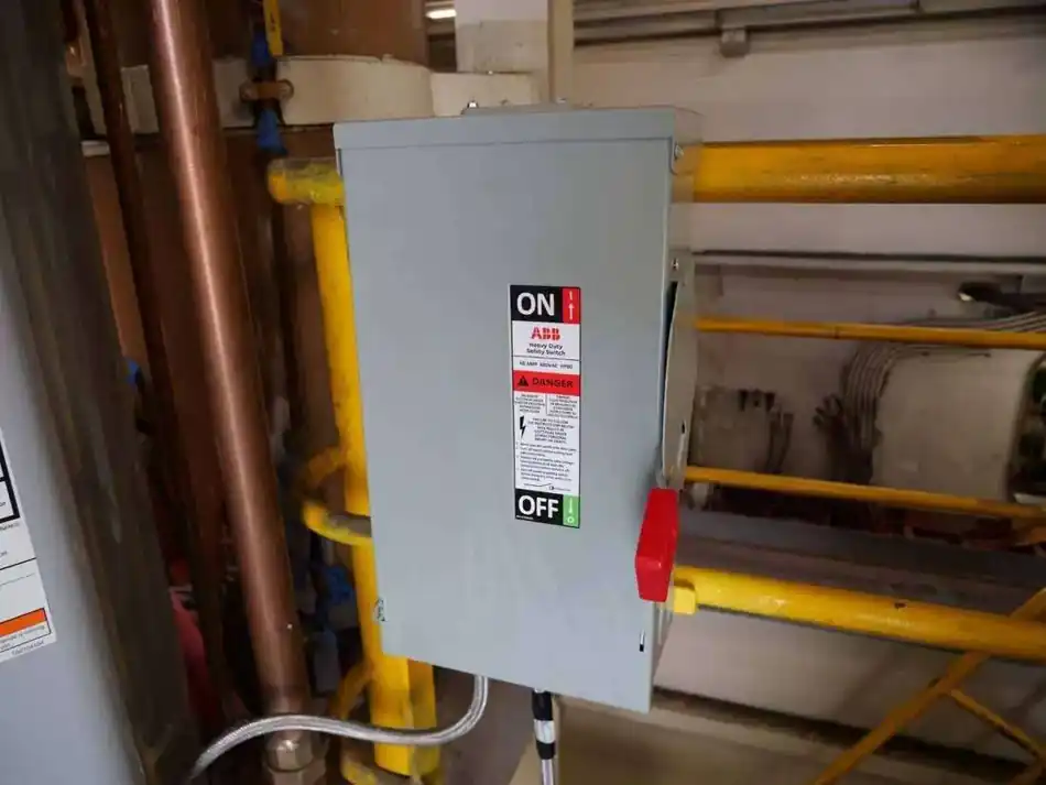 Heavy-duty electrical disconnect switch mounted near facility piping