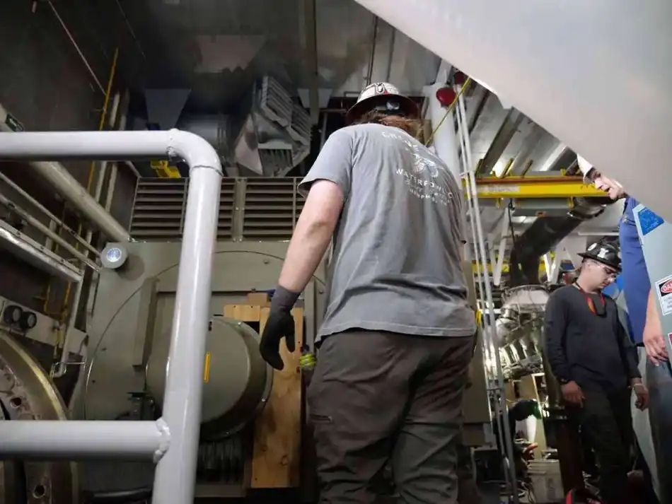Electrical technicians working in a vessel engine room