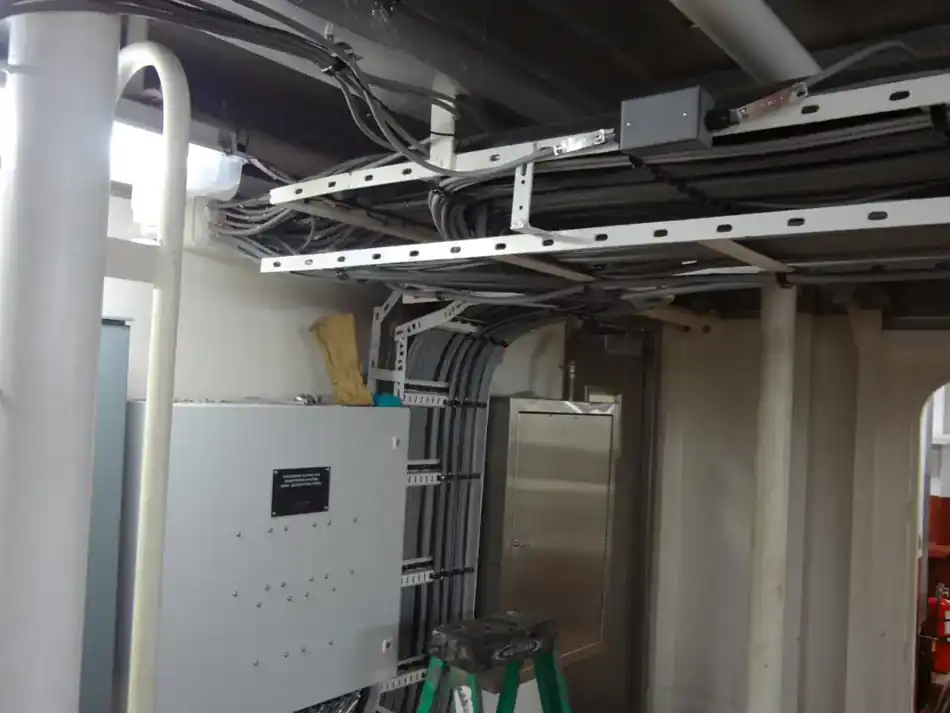 Electrical panel with overhead cable tray and routed conductors