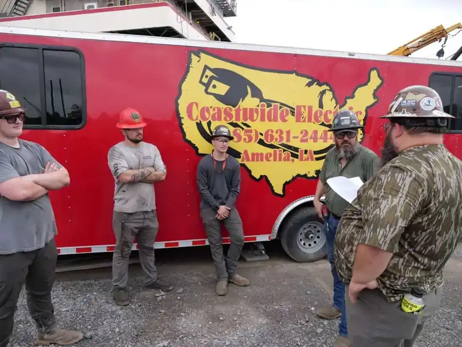 Coastwide crew gathered for a project briefing by the service trailer