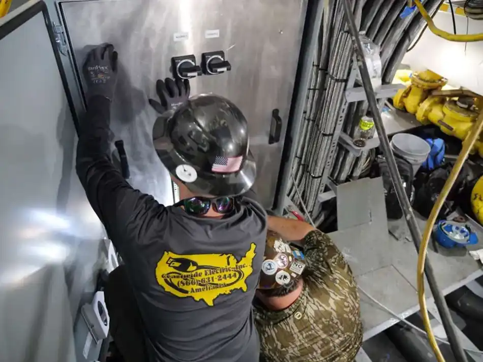 Coastwide technicians servicing a stainless electrical control panel