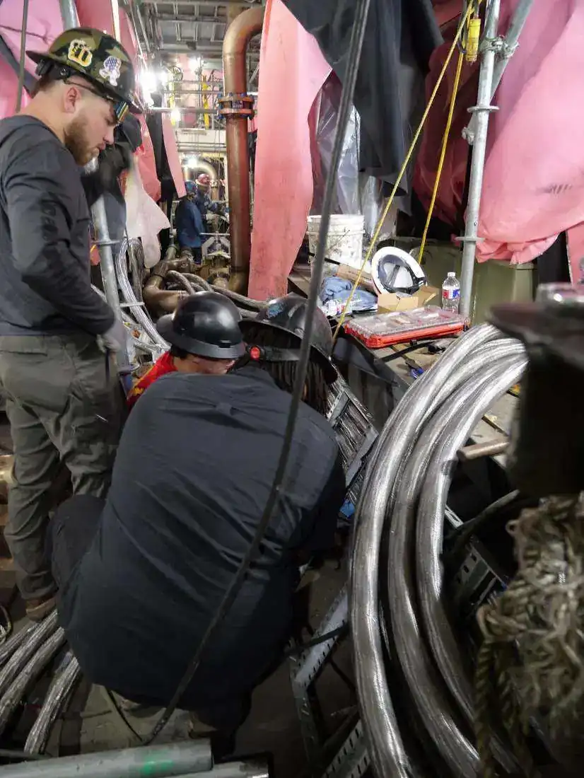 Electrical technicians working on a marine electrical installation